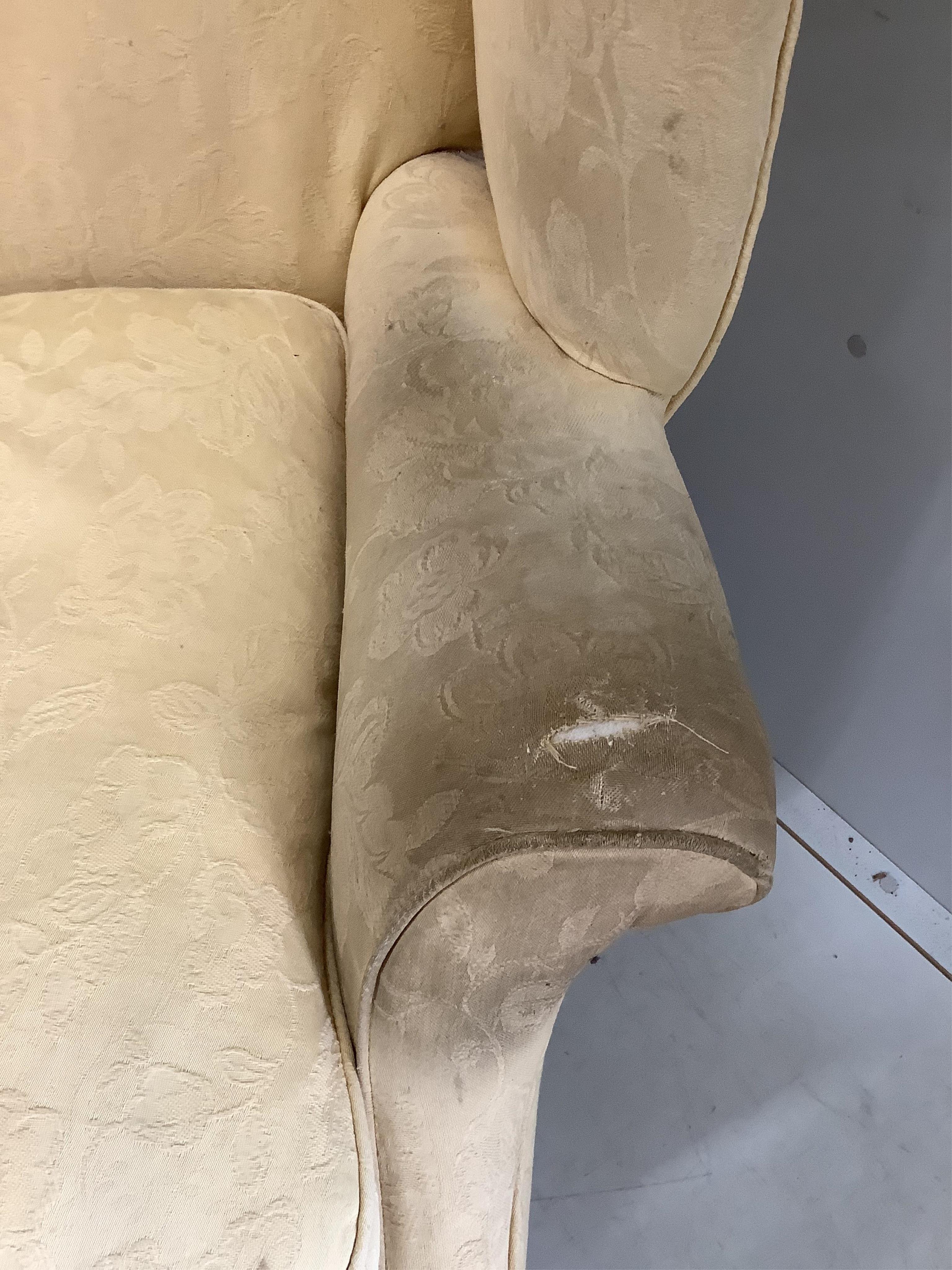 A George III upholstered wing armchair, width 86cm, depth 74cm, height 105cm. Condition - poor to fair